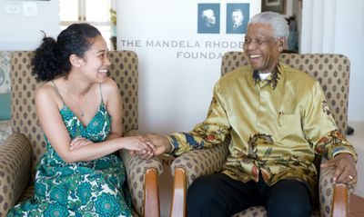 Nelson Mandela shaking hands with a Mandela Rhodes scholar